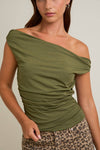 Model wearing dark olive off-the-shoulder ruched top in stretch knit fabric — fitted chic top available at TandyWear boutique in Commack, NY.