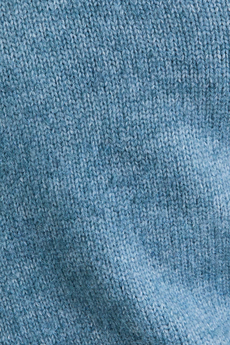 Soft light blue asymmetrical shoulder sweater top with a relaxed fit, perfect for layering in Long Island boutique fashion.