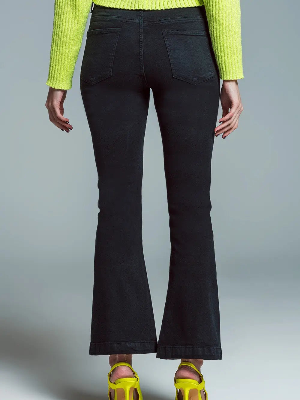 Model wearing black Skinny Flared Jeans with double button detail — stretch denim fit with modern flare, available at TandyWear Boutique in Commack, NY. front view