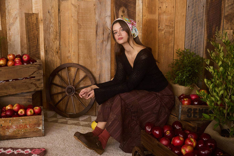 Chic black bell sleeve cardigan with front buttons and intricate crochet knit, perfect for a cozy look in Long Island boutique fashion.
