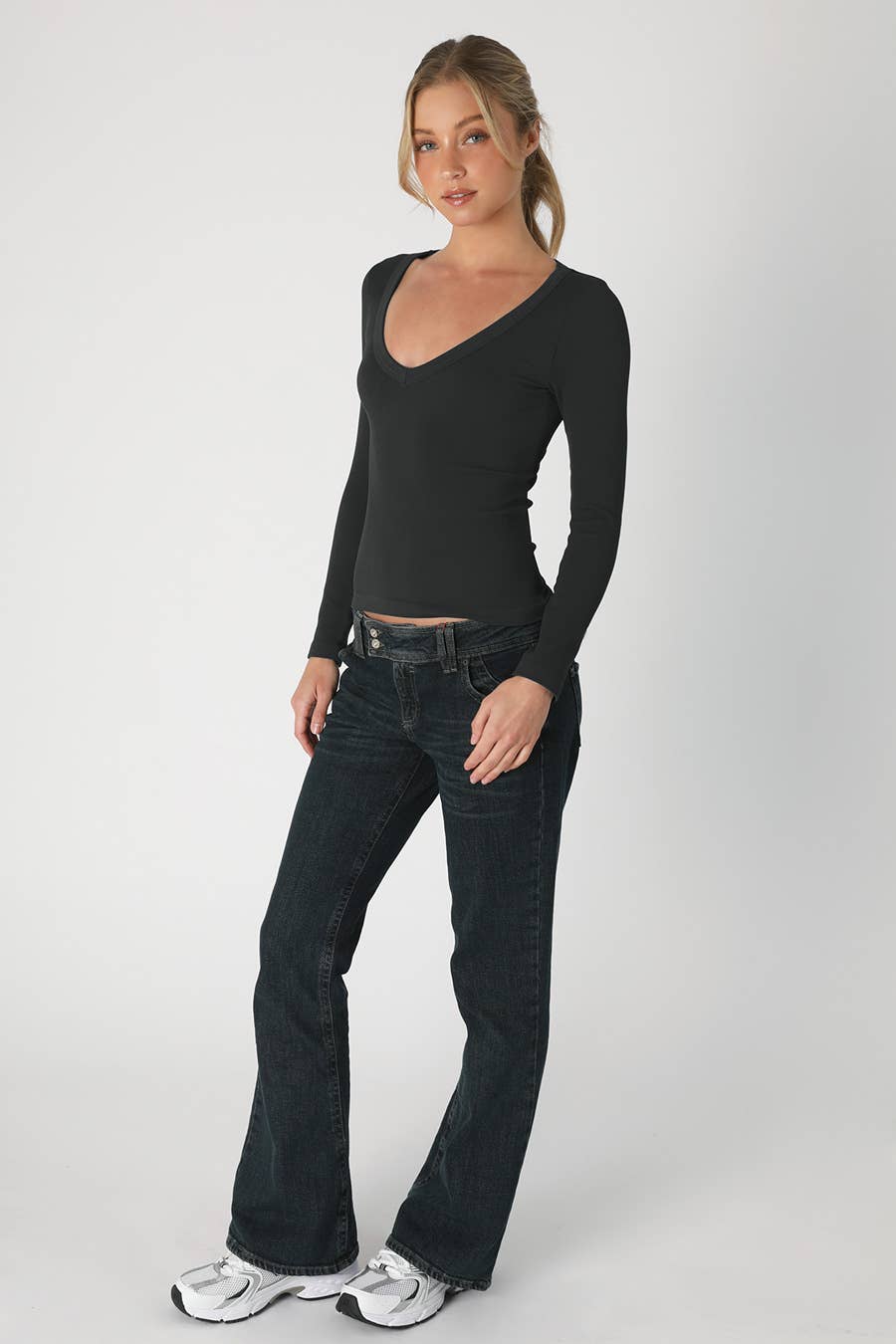 Chic black deep V neck long sleeve top with a fitted ribbed texture, perfect for layering in Long Island boutique fashion.