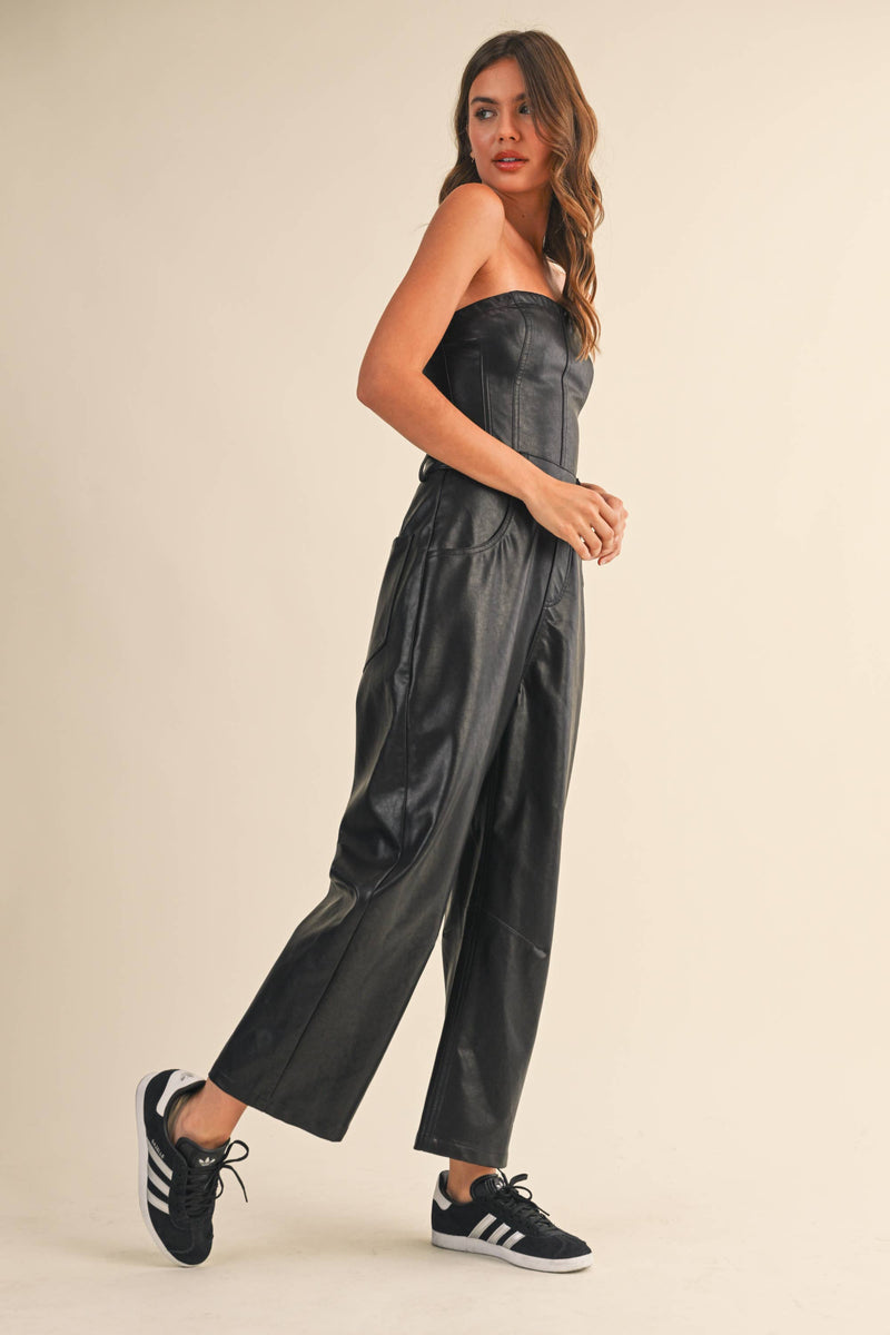 Strapless black faux leather barrel jumpsuit featuring a fitted bodice and wide-leg silhouette, perfect for Long Island boutique fashion.