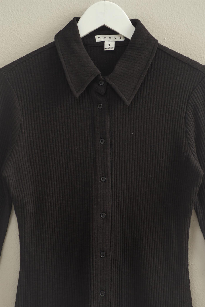 Chic textured black long sleeve button-down shirt featuring a classic collar and ribbed fabric, ideal for Long Island boutique fashion.