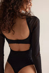 Black long-sleeve bodysuit featuring a delicate lace back and a form-fitting silhouette, perfect for Long Island boutique fashion.