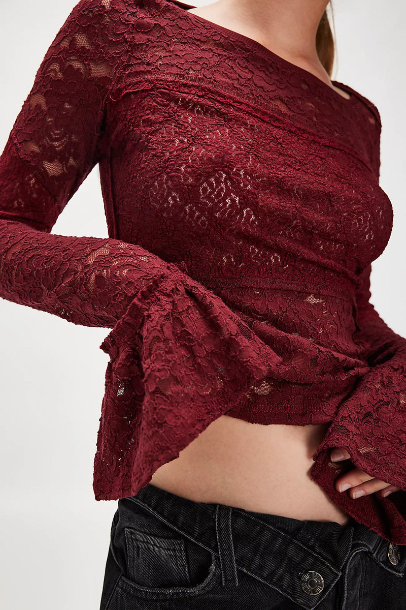 Luxe burgundy lace long sleeve top featuring a fitted silhouette, flared sleeves, and delicate floral patterns, perfect for Long Island boutique fashion.