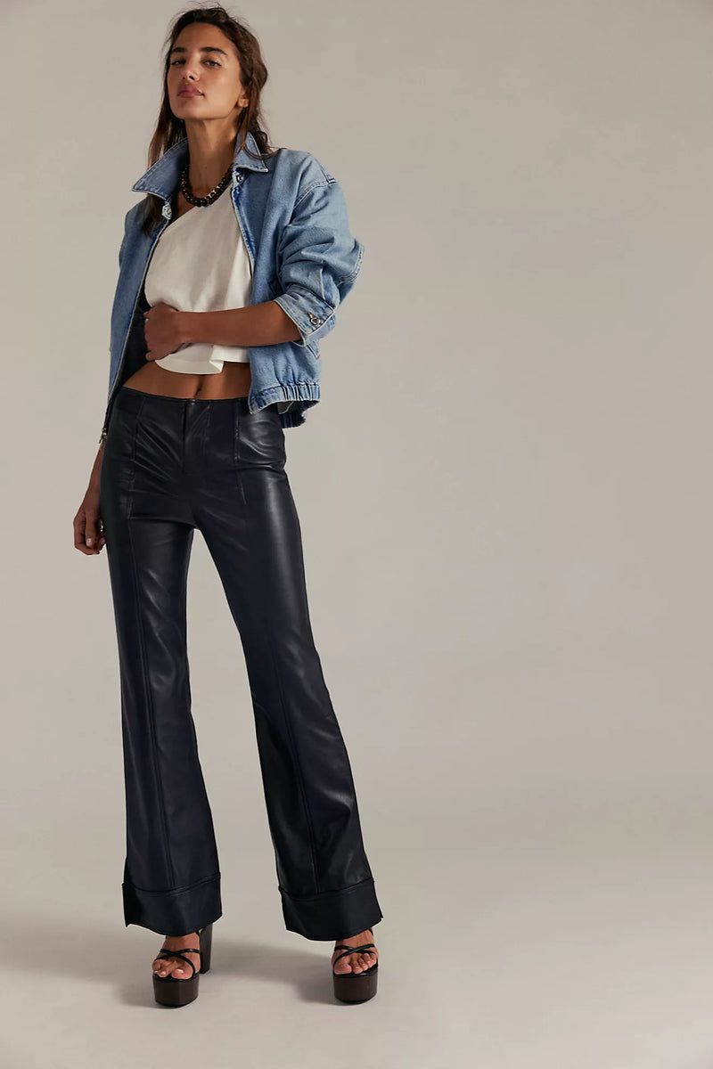 High-waisted black vegan pants with a sleek fit and flared hem, perfect for Long Island boutique fashion enthusiasts.