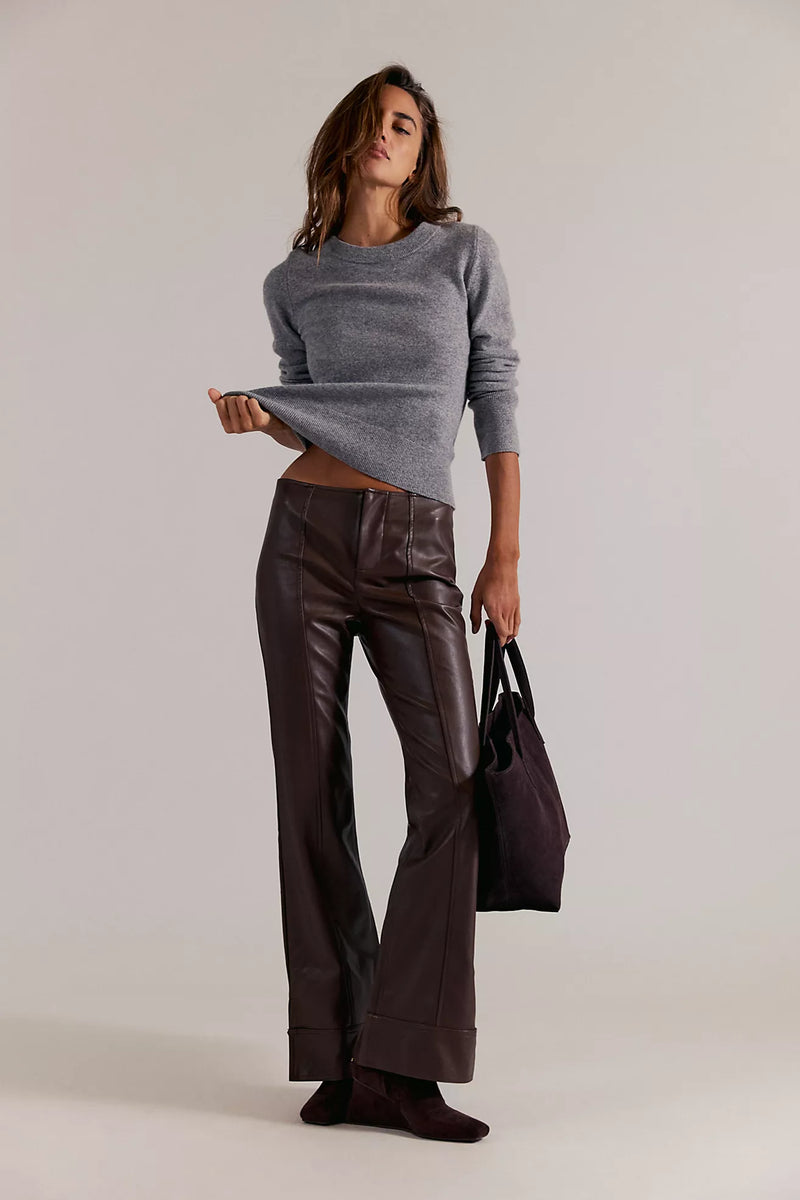 High-waisted vegan leather pants in deep brown, featuring a flared fit and sleek seams, perfect for Long Island boutique fashion enthusiasts.
