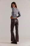 Vegan leather pants in rich brown with a sleek fit, flared legs, and stylish side slits, perfect for Long Island boutique fashion.