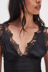 Lace-trimmed black tank top with a deep V neckline and pleated details, perfect for stylish layering in Long Island boutique fashion.