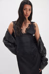 Sleek black Free People Elena Lace Tank Top featuring delicate lace trim, a fitted bodice, and a flattering silhouette for Long Island boutique fashion.