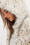 Ultra-soft hooded faux fur jacket in cream with subtle animal print, perfect for staying cozy in Long Island boutique fashion.