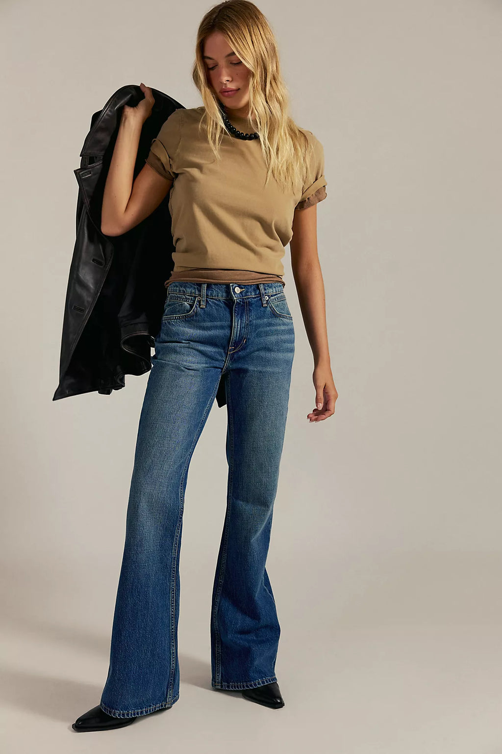 Relaxed-fit denim jeans in medium blue with a high waist and flared legs, perfect for Long Island boutique fashion enthusiasts.