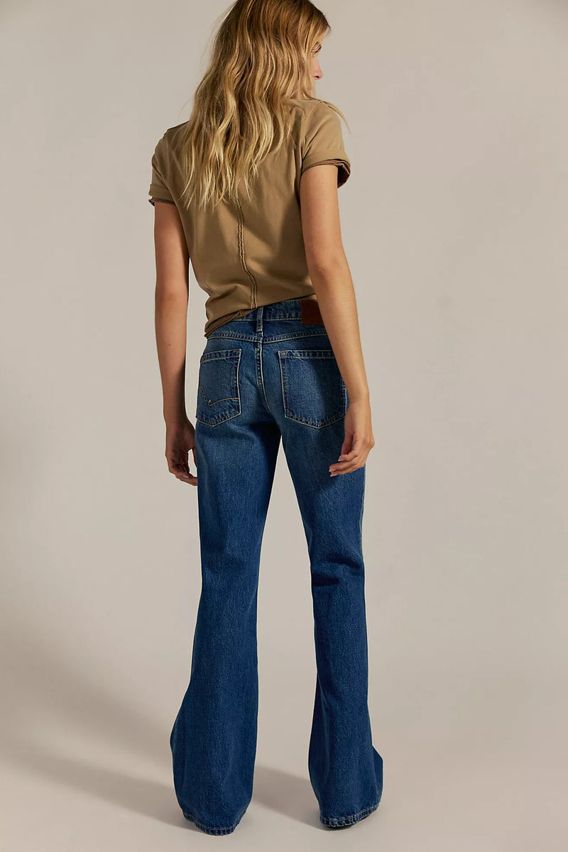 Relaxed-fit, flared blue jeans featuring classic back pockets, ideal for a casual look in Long Island boutique fashion.