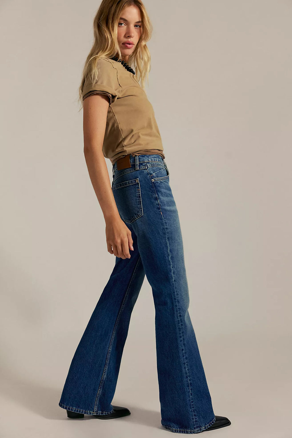 Relaxed-fit denim jeans in medium blue with a high waist and flared legs, perfect for Long Island boutique fashion enthusiasts.