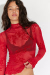 Lightweight red long sleeve top featuring floral lace patterns, a fitted silhouette, and ruffled cuffs, perfect for Long Island boutique fashion.