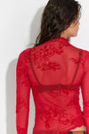 Sheer red long sleeve top with floral patterns and a fitted design, perfect for layering in vibrant Long Island boutique fashion.