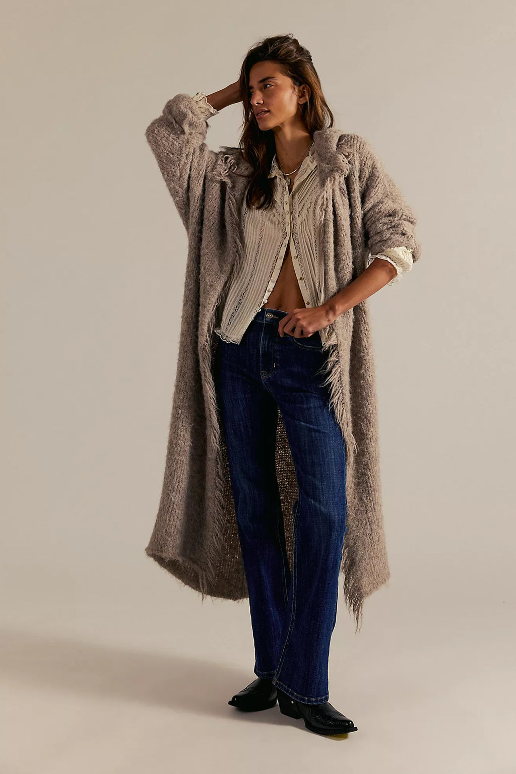 High-rise bootcut jeans in dark denim featuring a double knot detail, paired with a cozy long cardigan for a trendy Long Island boutique fashion look.