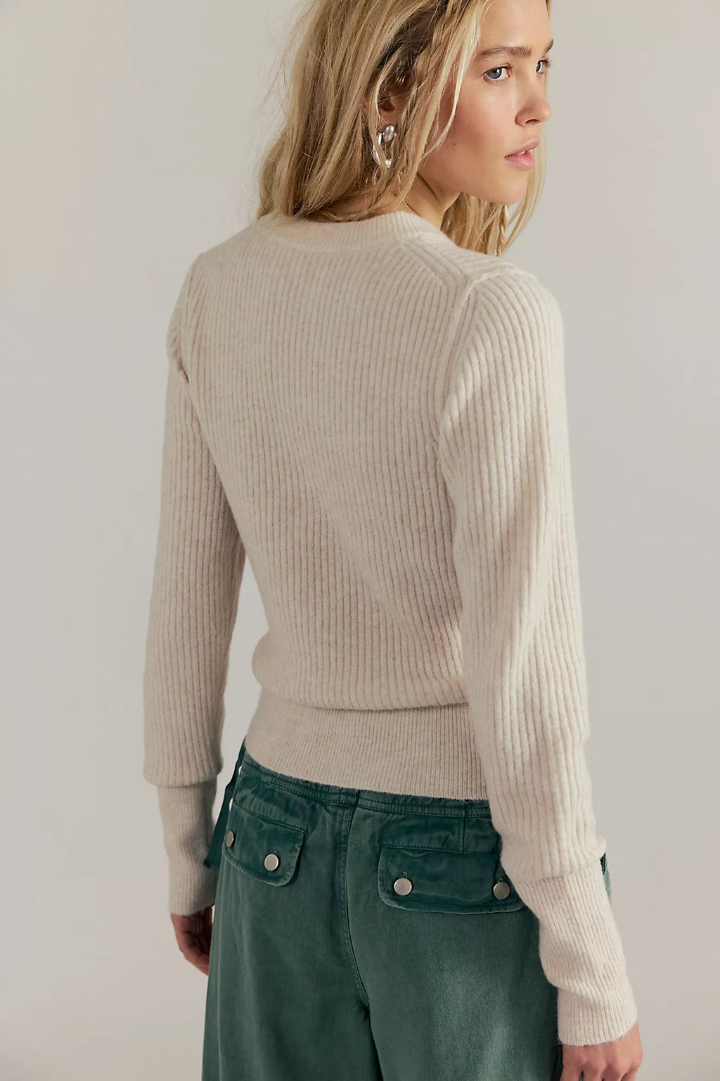 Soft cream ribbed pullover top with a fitted silhouette, perfect for layering in Long Island boutique fashion.