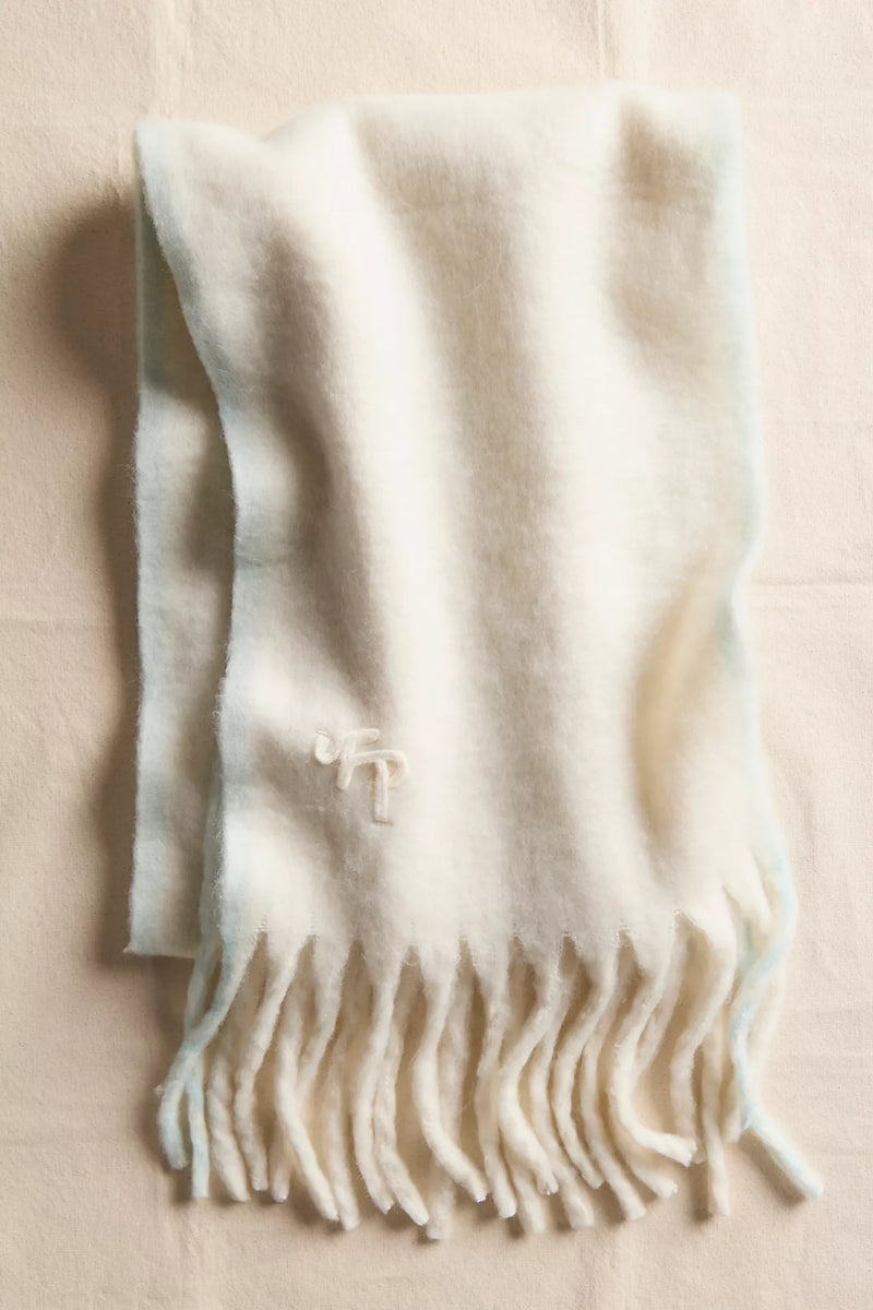 Cozy winter blanket scarf in soft cream with light blue edges, featuring fringe detail, perfect for Long Island boutique fashion.