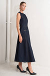 Sleek navy denim midi dress with a fitted bodice, side pockets, and a belted waist, perfect for Long Island boutique fashion enthusiasts.