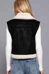Cozy faux suede inner fur vest in black, featuring a zip-up front and a chic collar, perfect for stylish layering from a Long Island fashion boutique.