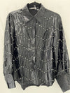 Elegant black embellished blouse top with a textured wave pattern and pearl accents, perfect for Long Island boutique fashion.