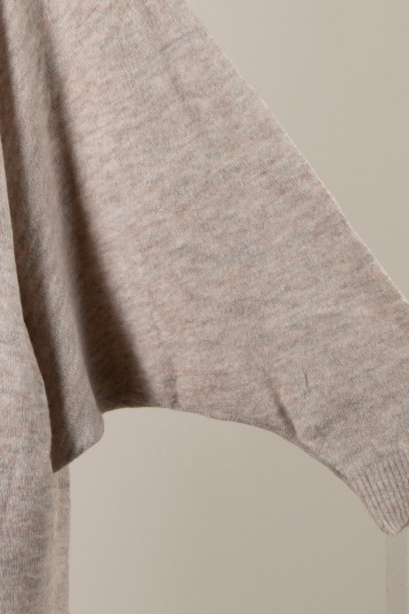 Soft knit oversized cardigan in a muted beige tone, featuring stylish batwing sleeves, perfect for Long Island boutique fashion.