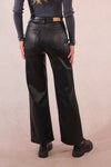 High-waisted black double button woven pants with a relaxed fit and shiny finish, perfect for Long Island boutique fashion looks.