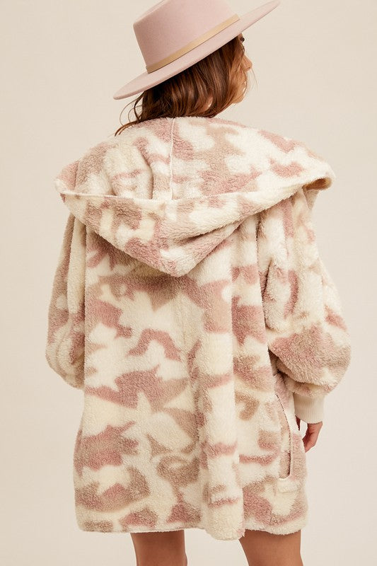 Soft, oversized teddy bear jacket in a cream and blush camo print with a cozy hood, perfect for Long Island boutique fashion.