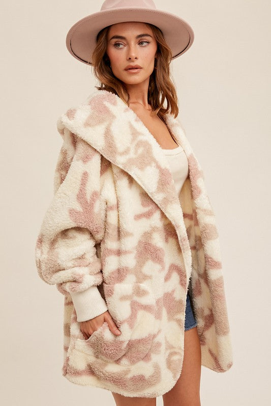 Oversized teddy bear jacket in soft cream and blush camo print, featuring a cozy hood and large pockets, perfect for Long Island boutique fashion.