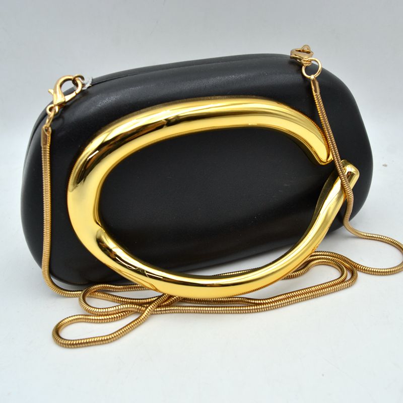 Sleek black evening bag featuring a striking gold hardware detail and a stylish chain strap, perfect for Long Island boutique fashion events.