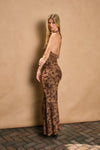 Draped halter neck maxi dress in rich brown with floral patterns, showcasing a fitted silhouette, perfect for Long Island boutique fashion.