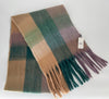 Plaid scarf with fringes and a tag on a white background