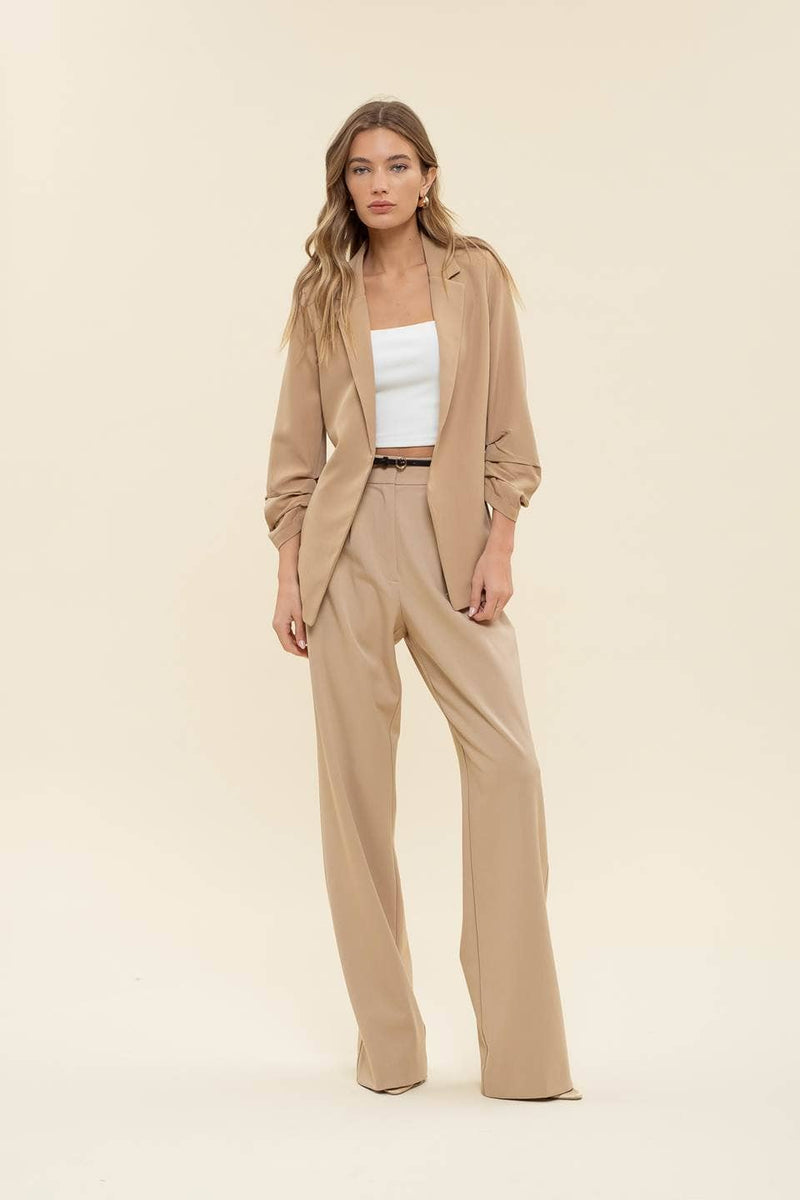 Beige 3/4 ruched sleeve blazer featuring a relaxed fit, paired with wide-leg trousers, ideal for stylish Long Island boutique fashion.