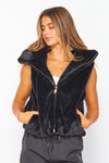 Soft black faux fur hooded vest featuring a zip front, stylish pockets, and a relaxed fit, perfect for Long Island boutique fashion.