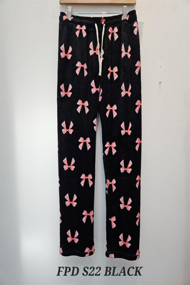 Black pants with pink bow pattern on a white background