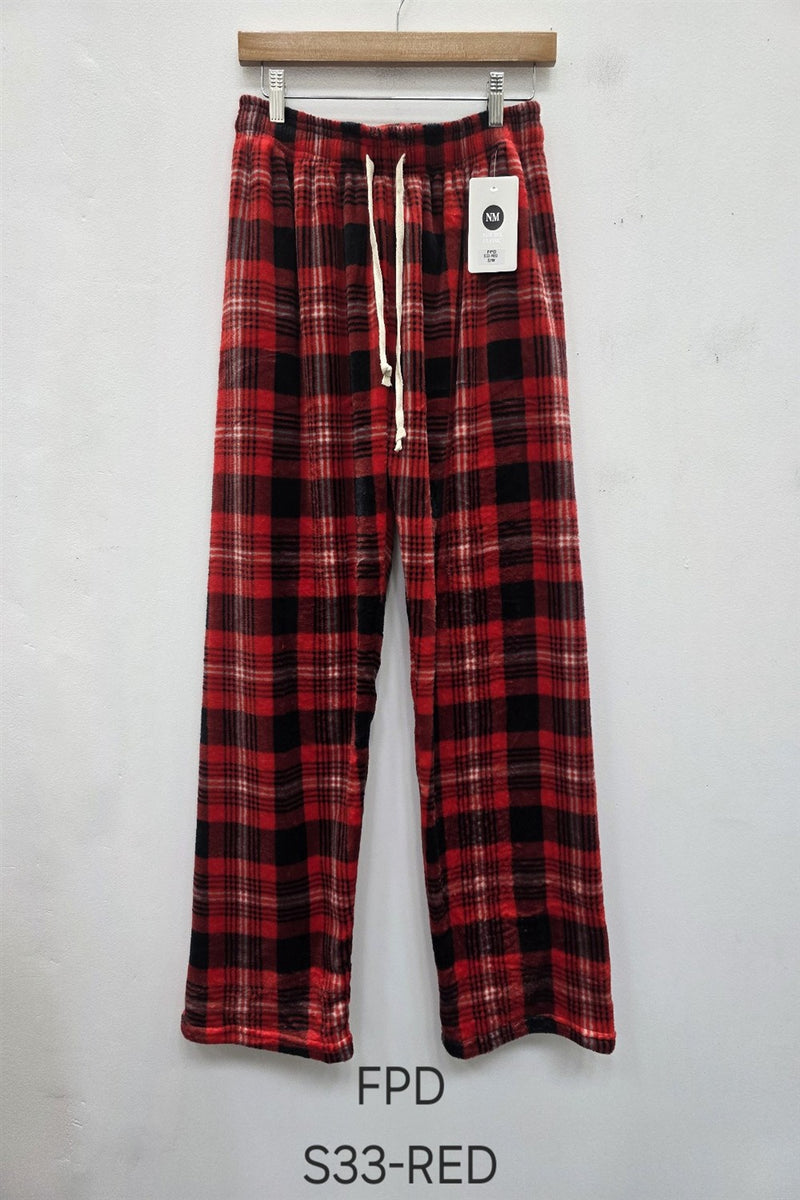 Red and black plaid pants on a hanger against a white background