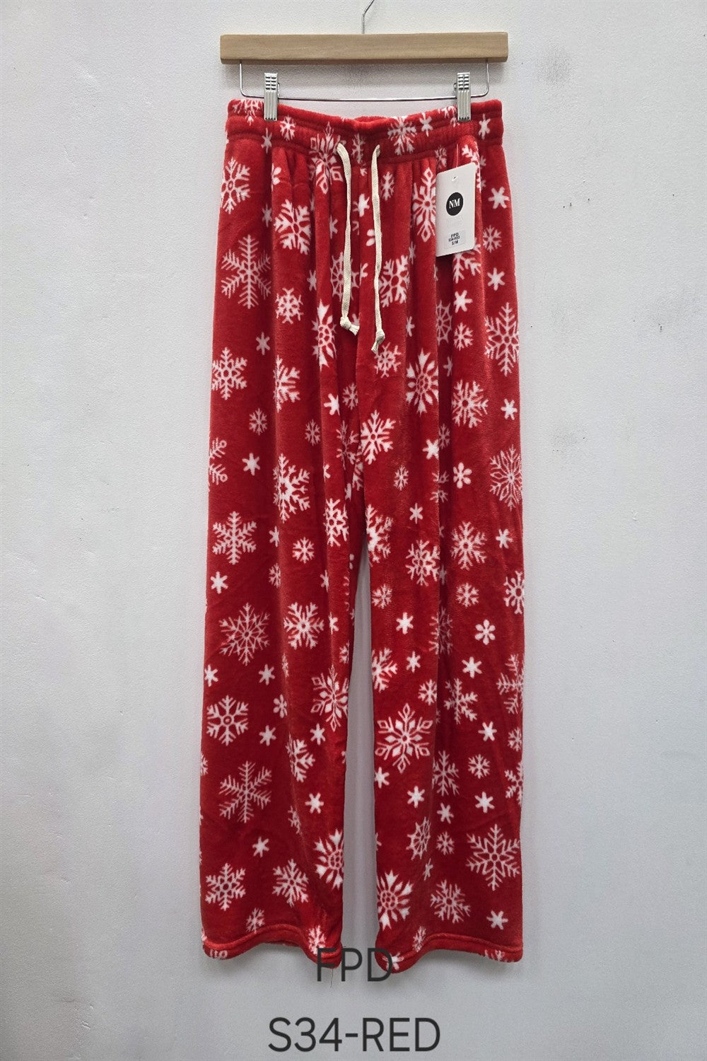 Model wearing pink fuzzy printed pajama pants with cherry print