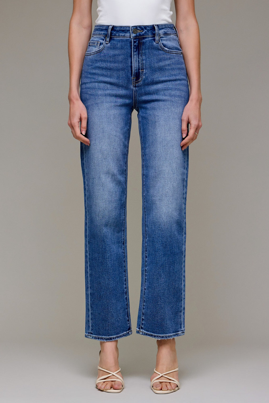 Model wearing Hidden Tracey High Rise Straight Jeans in medium dark wash — classic straight-leg denim with raw hem, available at TandyWear Boutique in Commack, NY. front view