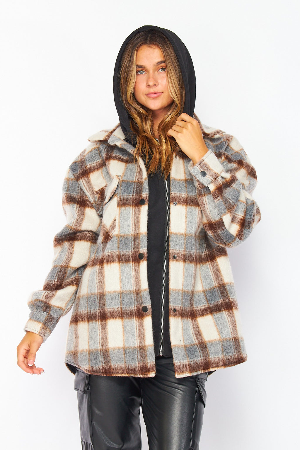 Person wearing a plaid jacket with a hood on a white background