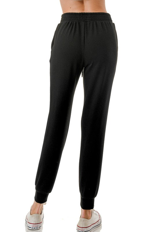Black joggers featuring a comfortable elastic waistband and a stylish sequin drawstring, perfect for laid-back Long Island boutique fashion.