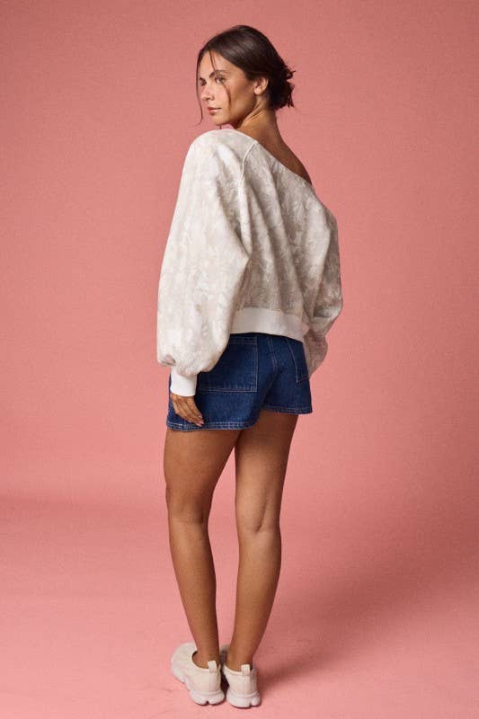 Off-shoulder camo print long sleeve top in soft beige with puffed sleeves, paired with denim shorts, perfect for Long Island boutique fashion.