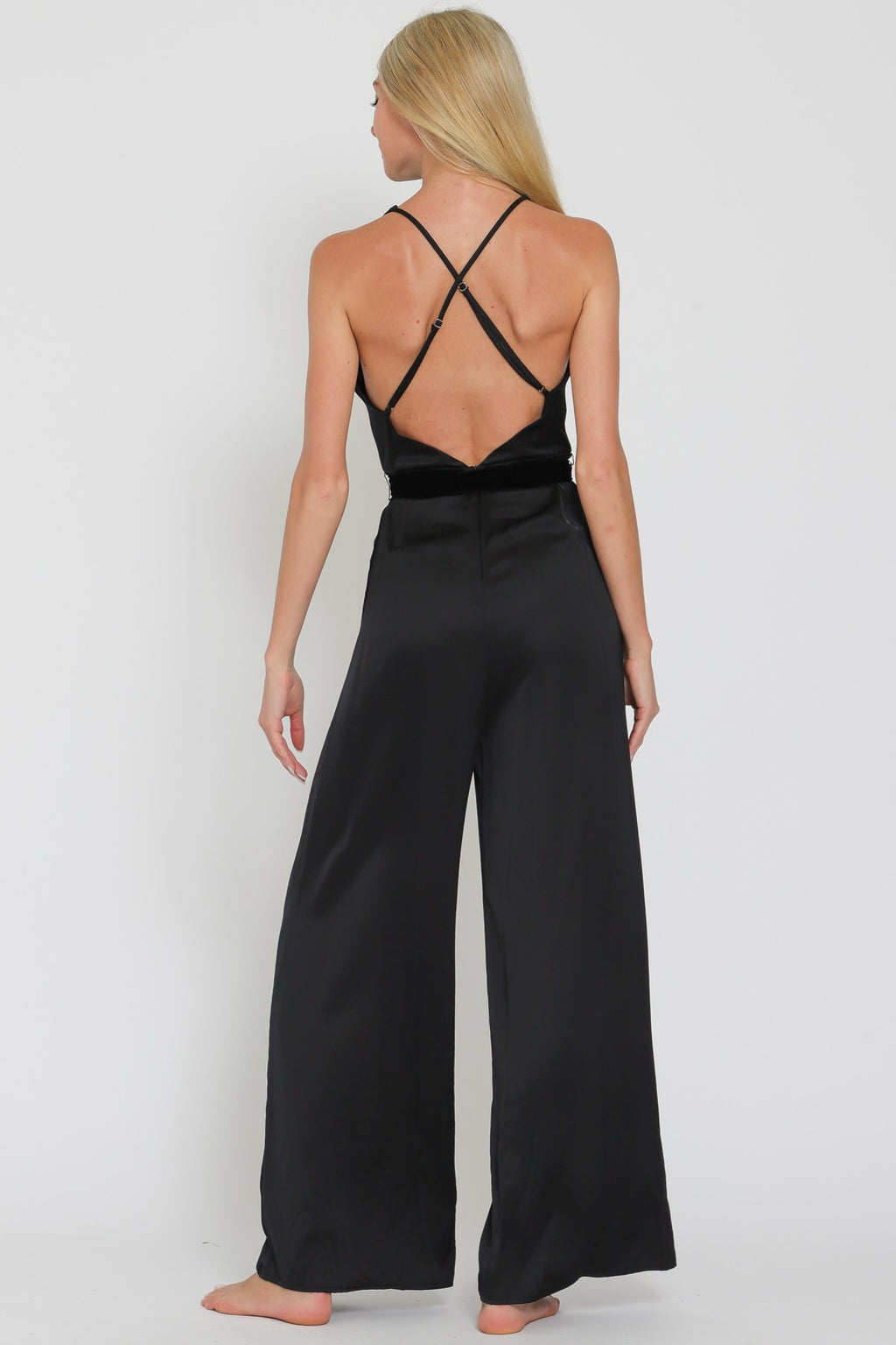 Sleek black cowl sleeveless jumpsuit with a belted waist and wide-leg fit, embodying elegance for Long Island boutique fashion.