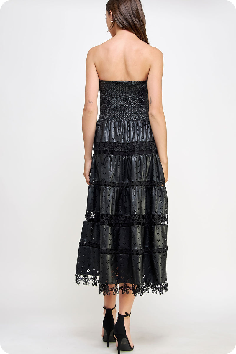 Strapless black eyelet faux leather midi dress with a smocked bodice and tiered lace-trimmed hem, perfect for Long Island boutique fashion.