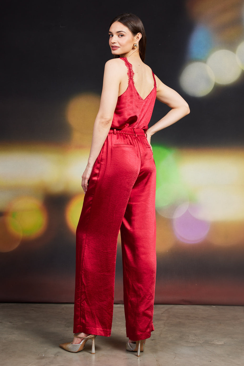 Dull satin elastic back trouser in rich red featuring a relaxed fit, high waist, and side pockets, perfect for Long Island boutique fashion.