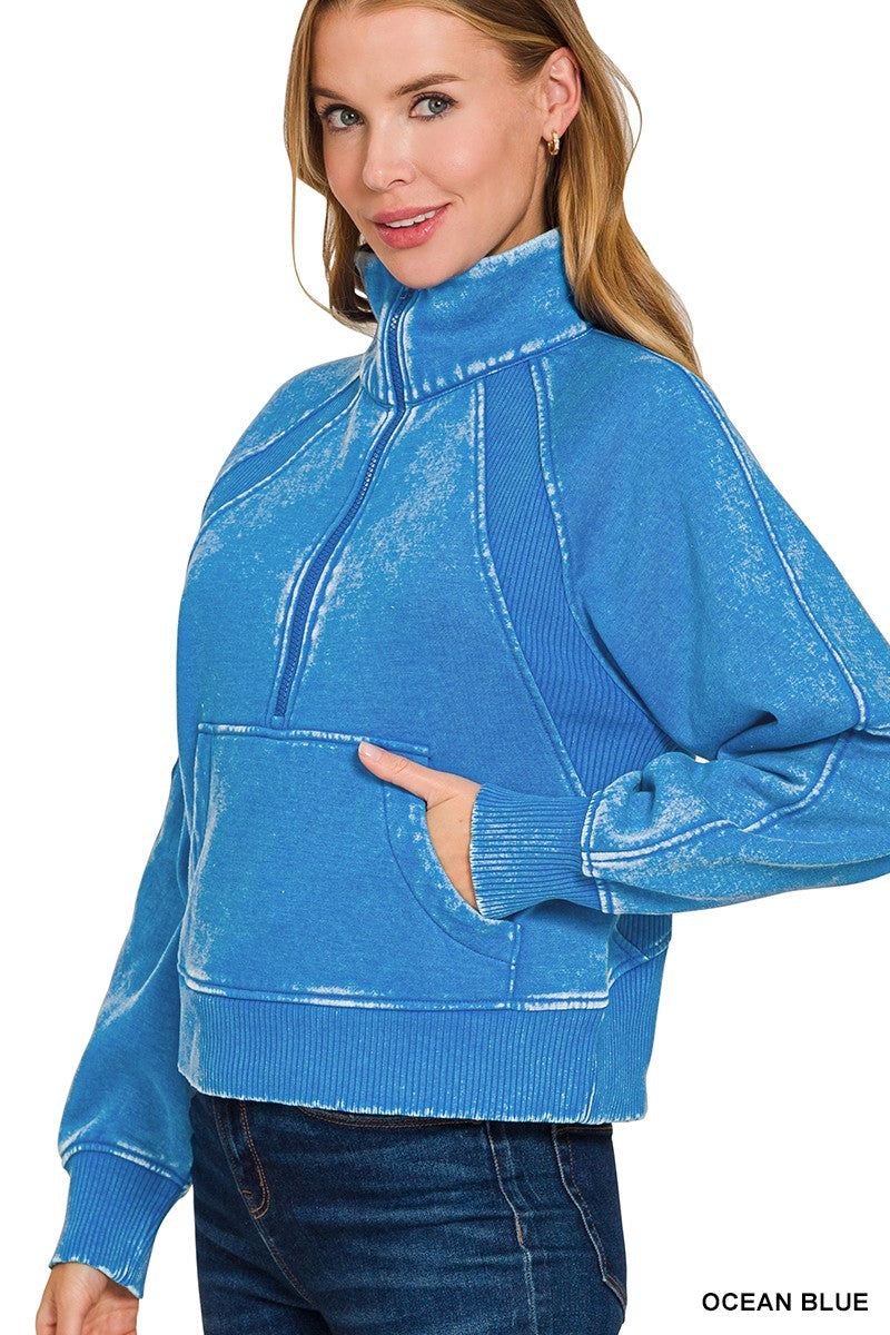 Acid washed ocean blue half zip fleece pullover features a kangaroo pocket, ribbed cuffs, and a relaxed fit, perfect for Long Island boutique fashion.