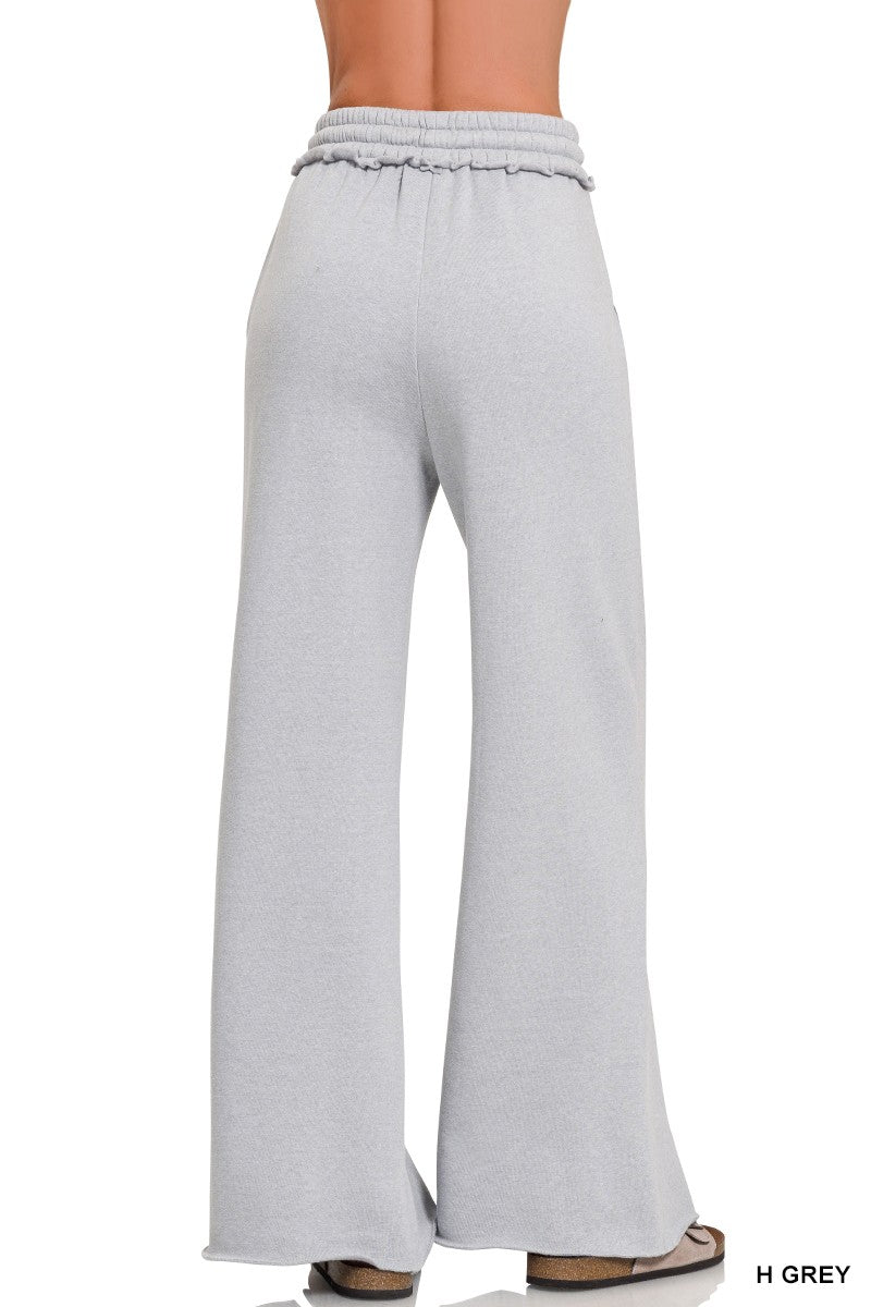 Soft grey fleece wide-leg sweatpants featuring exposed seams and a relaxed fit, perfect for lounging in Long Island boutique fashion.