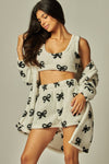 Cozy fleece 3-piece pajama set featuring a black bow pattern on a soft white background, perfect for stylish comfort from a Long Island women’s boutique.