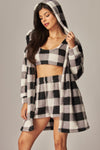 Cozy fleece three-piece pajama set featuring a hooded cardigan, crop top, and shorts in a stylish black and white plaid pattern, perfect for Long Island boutique fashion.