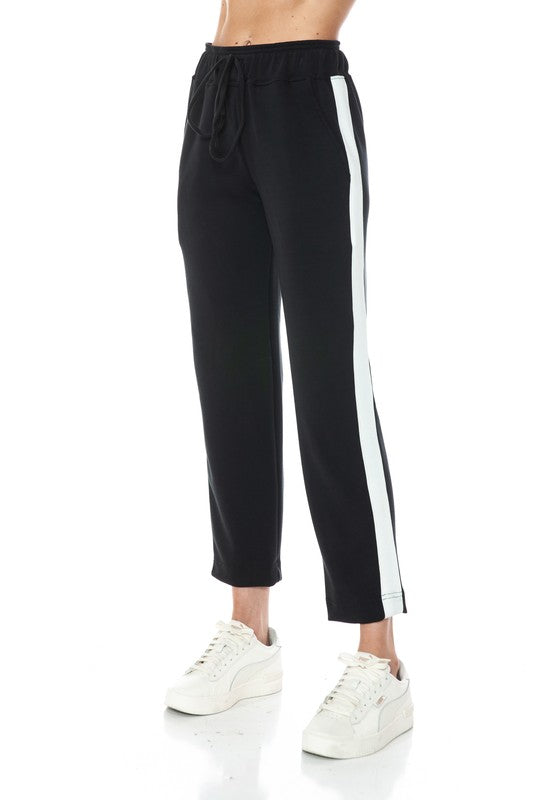 Straight leg two-tone pants in black with a white side stripe, featuring an elastic waistband, perfect for Long Island boutique fashion.